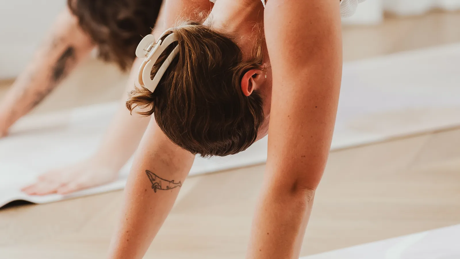 Two women in downward dog on mats during a yoga class at Davaar House